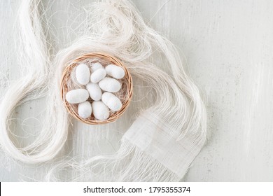 silkworm cocoon, top view Silk cocoons commercially bred caterpillar of silkworm moth, fiber thread and fabric made from silkworm cocoons.