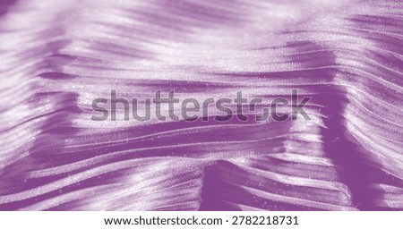 Silky layers drape in gentle waves, interspersed with elaborate lace details that sparkle under soft light, evoking an opulent aura across the regal purple satin. Folds add sumptuous appeal.