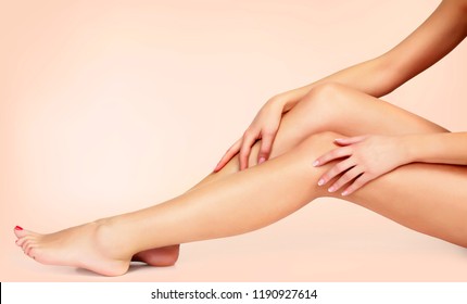 Silky Smooth Skin Of Female Legs After Depilation. Woman Touches Her Legs By Hands