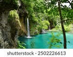 Silky smooth waterfalls flowing into turquoise blue lake, scenic Plitvice Lakes National Park, popular landmark in Croatia, travel europe