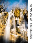 Silky waterfalls at Plitvice lakes national park, lit by the gentle, winter sun