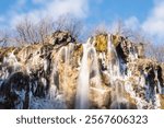 Silky waterfalls at Plitvice lakes national park, lit by the gentle, winter sun