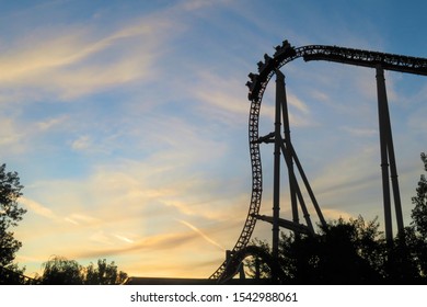 Sillhouette of a cart at the top of the hill on a roller coaster at sunset.  Copy space - Powered by Shutterstock