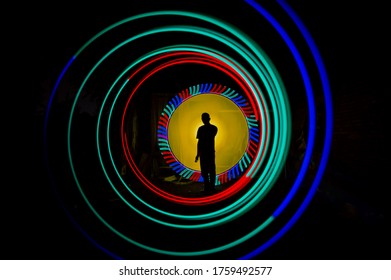 Sillhouette Indonesian People Standing Alone With Beautiful Circle Light Painting On The Dark Background