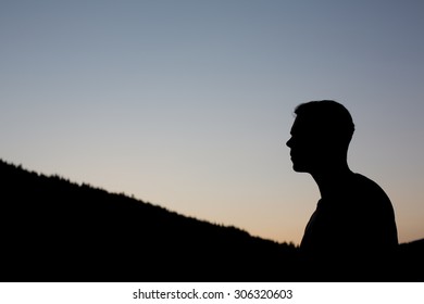 Sillouette Of Handsome Man Guy Tourist Standing Alone Thinking By The Mountain River Waterfall Forest During His Summer Vacation