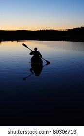 Sillouette Of Man Kayaking On Lake