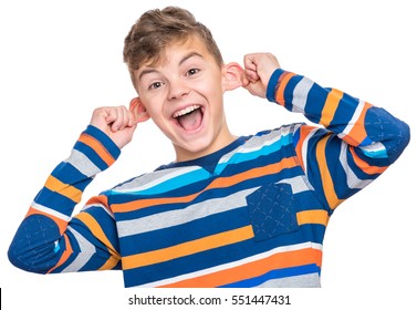 Silly boy making grimace - funny monkey face. Child with big ears, isolated on white background. Emotional portrait of caucasian teenager looking at camera.