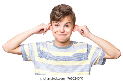 Silly boy making grimace - funny monkey face. Child with big ears, isolated on white background. Emotional portrait of caucasian teenager looking at camera.