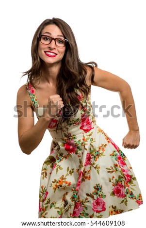 Silly fun high spirited youthful nerdy brunette woman dancing funny in dress