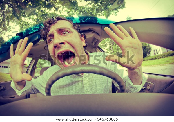 Silly\
man gets into car crash and makes ridiculous\
face