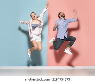 Silly mood. Couple of young funny and happy man and woman having fun isolated over blue and pink background. Human emotions, youth, love and active lifestyle concept