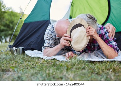 Silly Senior Couple In Tent Is Hiding Behind A Hat At The Campsite