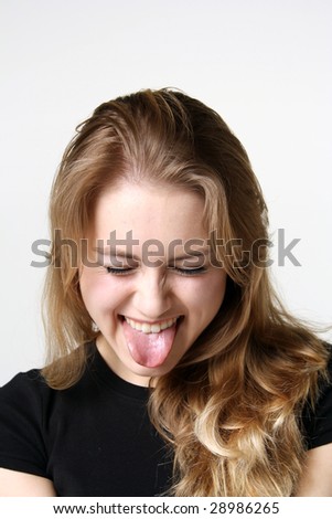 Similar – Young happy woman sticking out her tongue