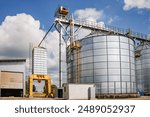 silos on agro-industrial complex with seed cleaning and drying line for grain storage. Granary elevator