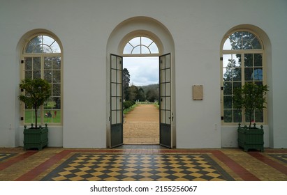 SILSOE, BEDFORDSHIRE, ENGLAND - APRIL 13, 2022: Inside The Orangery Looking Out To A Formal Garden