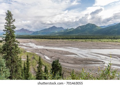 Silt Laden Glacial Waters Stream Down From The Mountains Creating Mud Flats In Denali National Park, Alaska.