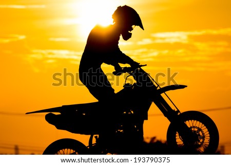siluate of motard racer back sun light