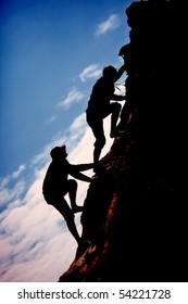 Siluet two men climb up the mountain