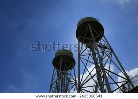 siluette water tank tower with blue sky