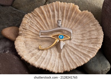 Silver amulet Eye of Horus . Eye of Ra on natural Background .