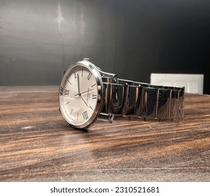 silver analog watch on table side view - Powered by Shutterstock