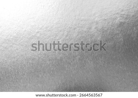 Silver background foil leaf metallic texture wrapping paper shiny glowing white grey solid reflective gradient color metal pattern backdrop for wallpaper decoration element backdrop