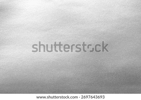 Silver background foil leaf metallic texture wrapping paper shiny glowing white grey solid reflective gradient color metal pattern backdrop for wallpaper decoration element backdrop