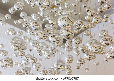 Silver ball hanging from ceiling as interior decoration inside shopping mall