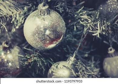 Silver ball on a Christmas tree in an artificial frost