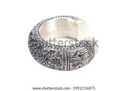 Silver bangle with leaves and flower pattern design isolated on white background. Thick and large silver bracelet with flower and leaf surface