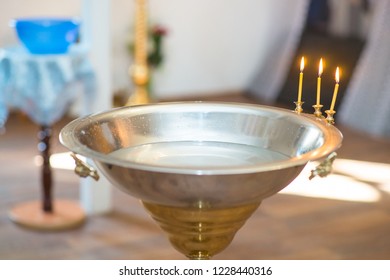 Silver bath for baptism ceremony inside church with decoration closeup