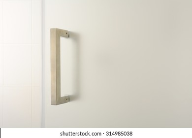 Silver Bathroom Door Handle On Opaque Glass Background