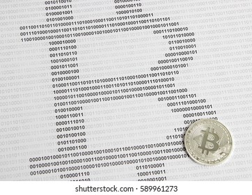silver bitcoin on the background of binary code