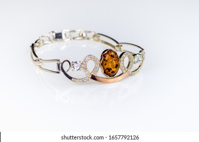 Silver bracelet with patterns decorated with orange stone