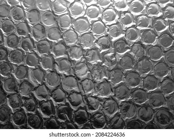 silver bubble wrap surface. plastic with air balls on the surface used for packing glassware or electronics or sensitive items
