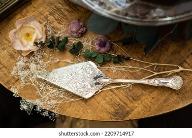Silver Cake Cutter On Rustic Background