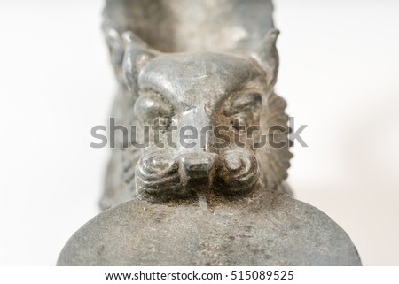 Silver candlestick in the form of an animal with wings on a white background. Isolated