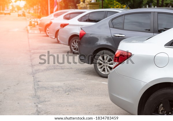 Silver\
car parking in line and car running\
background.