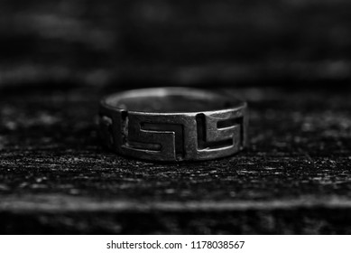 A Silver Celtic Ring On A Wooden Table.