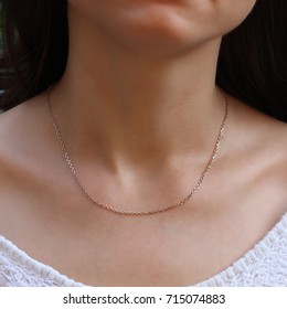 Silver Chain At The Neck Of A Woman