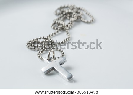 
Silver christian cross necklace isolated on white