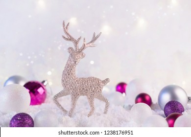 Silver christmas decoration deer and christmas balls on a pink winter background. Christmas holiday mood. Magic and fairy tale Template, greeting card
