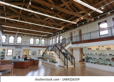 Silver City, New Mexico USA - July 30, 2019: Interior Of Historic 1917 Fleming Hall, Western New Mexico University, Main Floor With Reception Desk And Displays Of Prehistoric Mimbres Mogollon Pottery