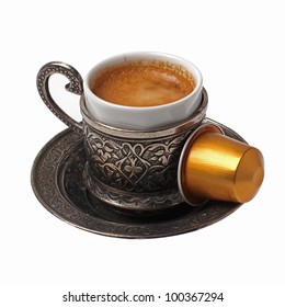 Silver coffee cup with capsule isolated on white