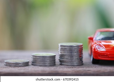 Silver Coin Of Pile With Red Car Model In Concept Savings To Buy A New Car Or Value Of Car And Journey Insurance.