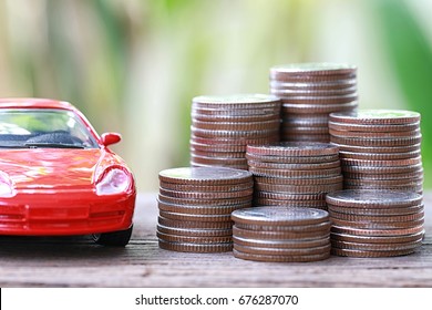 Silver Coin Of Pile With Red Car Model In Concept Savings To Buy A New Car Or Value Of Car And Journey Insurance.