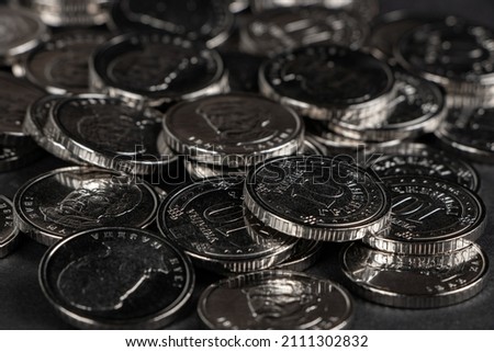 Silver coins background. Ukrainian 10 hryvnias coins. Money and finances. Ukrainian coins