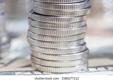 Silver Coins Folded Towers And Lying On The Paper Currency Of U.S. Dollars, Close-up International Foreign Currency