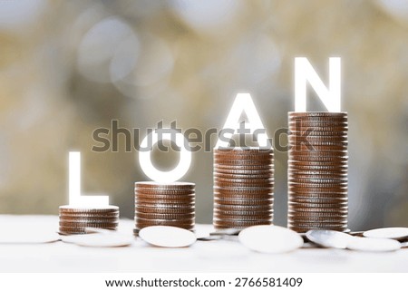 Silver coins stack in a row with white letters spelling loan. Growing loan and financial debt concept.