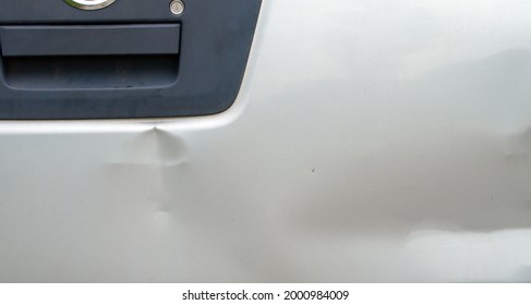 A Silver Colored Tailgait Has Been Dented In A Fender Bender Accident. Some Auto Body Repair Would Be Beneficial For The Truck Appearance. 